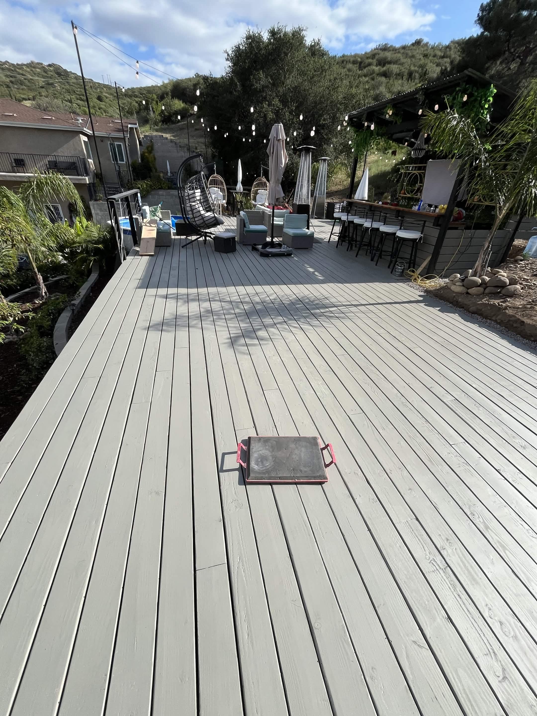 Finished hillside deck project with seating and outdoor entertaining space