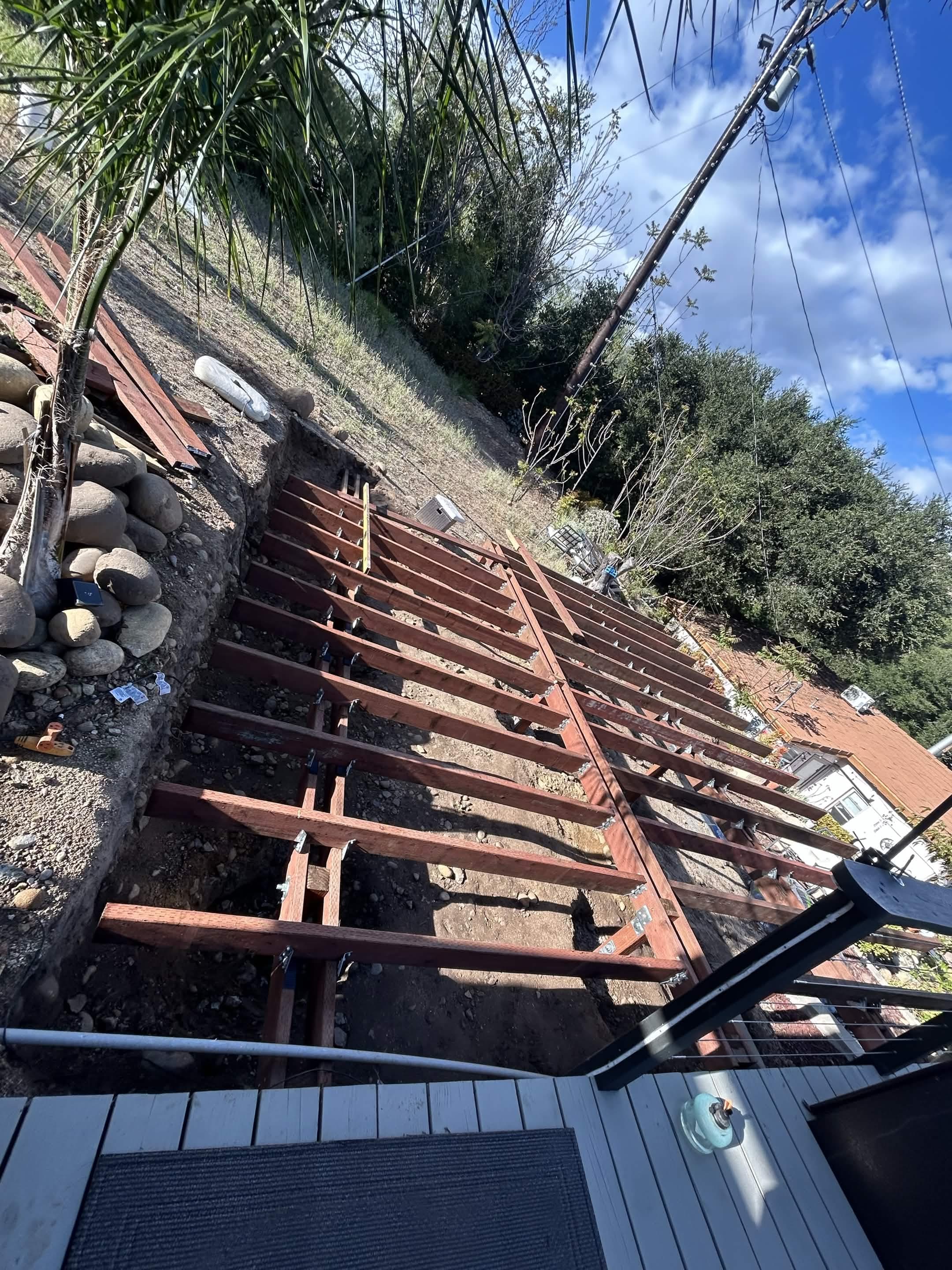 Hillside deck framing under construction before deck boards were installed